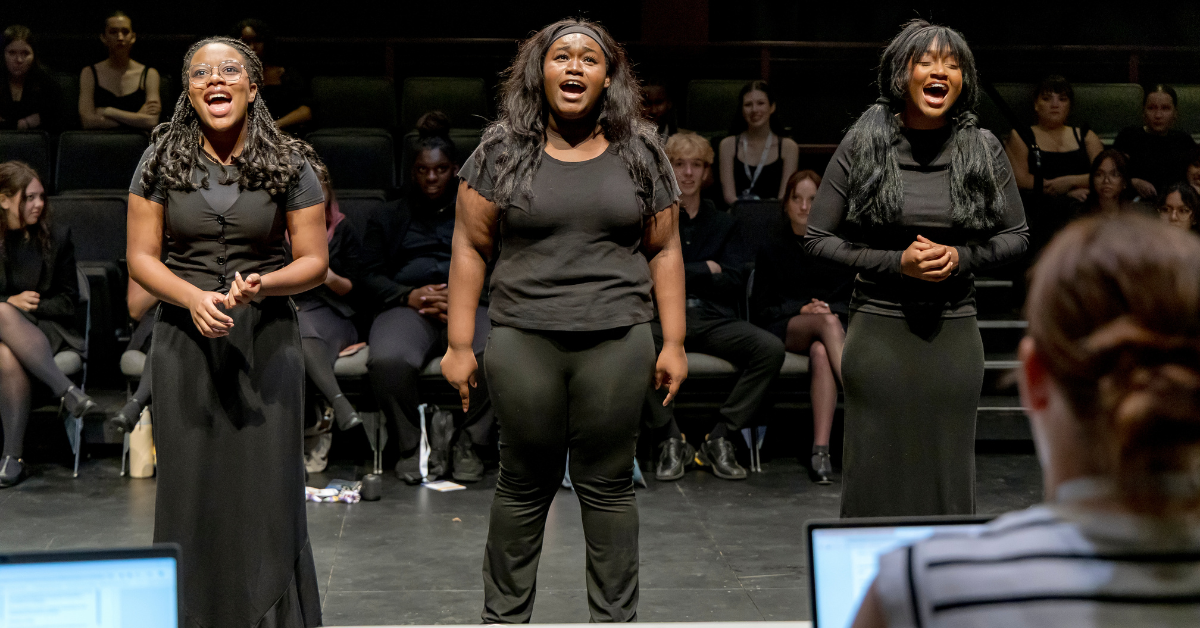 Three students performing at a theatre audition